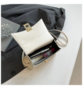 Detail view of the open white square bag showing internal capacity for phone and cosmetics