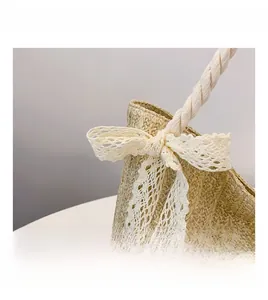 Detailed close-up of straw woven bag with white lace bow and sturdy rope handles