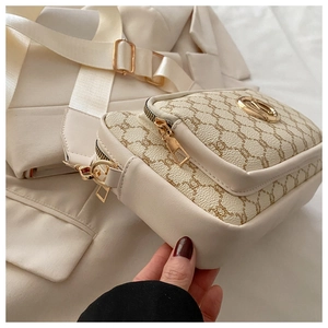 Detail of elegant crossbody bag featuring vintage floral print and golden round buckle