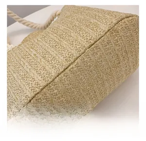 Detail showing high-quality stitching and tight straw weaving on the bottom of the tote bag