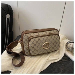 Detail of vintage monogram bag with dual zippers and golden M logo on a silk base