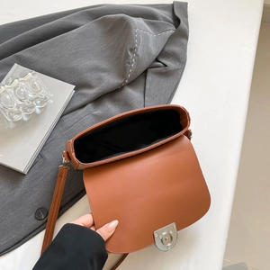 Brown vintage leather crossbody bag with silver magnetic clasp and interior detail