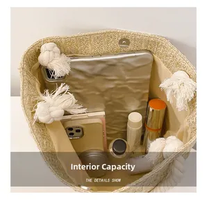 Internal capacity detail of straw woven tote showing spacious storage for tablet and makeup