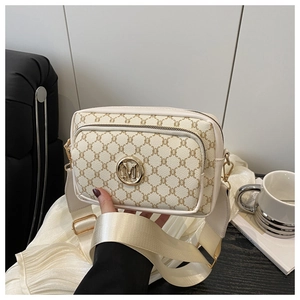 Detail of vintage beige monogram crossbody bag with metallic logo and fabric strap