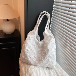 Minimalist white tote bag with floral lace embroidery and soft textured fabric handle