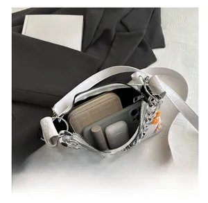 Detail view of the large capacity interior of the white floral crocodile pattern shoulder bag