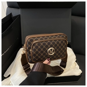 Detail showing vintage camera bag with M logo in premium gift box with wide strap