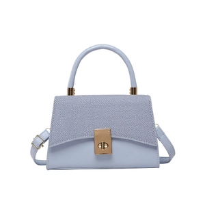 Contrast color trapezoid handbag in light blue with gold clasp and top handle
