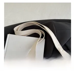 Detail of elegant white lace floral pattern and leather strap on a chic shoulder bag