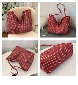 Detail view of red canvas tote with white polka dots, including stitching and interior