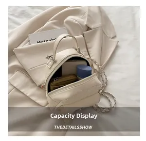 Detail view of the spacious interior of beige quilted handbag with daily essentials