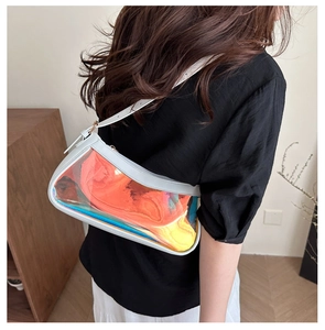 Detailed view of iridescent PVC shoulder bag with white leather trim on a model