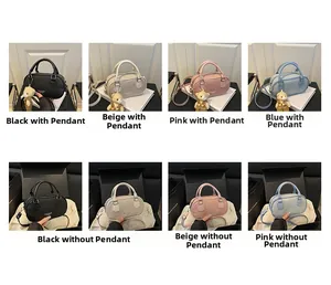 Matrix display of cylindrical PU handbags in four colors with bear charm and strap options