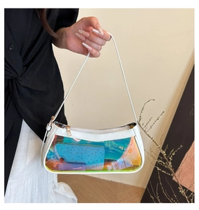 Detail of white leather frame and iridescent clear PVC panel on the tote bag