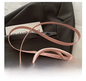 Detail of pink lychee textured leather handbag with adjustable strap and silver hardware
