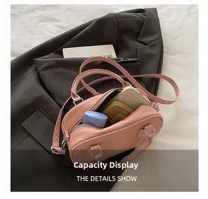 Detail view of pink bowling bag interior showing capacity for phone and cosmetics