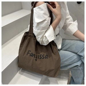 Brown canvas tote bag with Fanyissa logo shown in a casual lifestyle setting