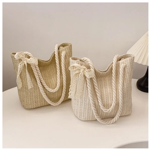Detail of woven tote bags with thick cotton rope handles and delicate lace bow accents