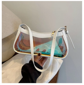 Detailed close-up of a transparent laser PVC shoulder bag with white leather trim