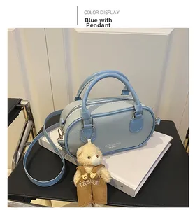 Detail of light blue lychee texture bag with bear charm and Muok Coconer logo text
