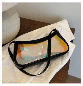 Detail of holographic clear PVC underarm bag with black leather trim and zipper closure