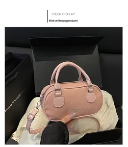 Detail of pink pebbled leather Boston bag with silver hardware in a luxury gift box