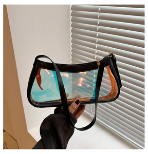 Detail of holographic clear bag showing black leather strap and golden zipper closure