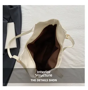 Detail view of large white tote bag interior with brown lining and zipper closure