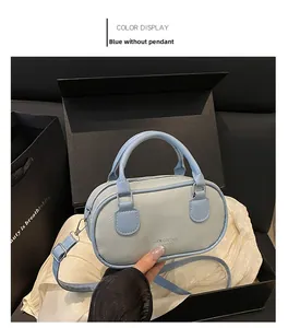 Close-up of a light blue lychee pattern mini bowling bag in a black gift box