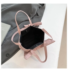 Detailed interior of pink bow tote bag showing spacious black lining and magnetic closure