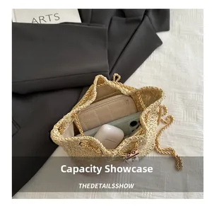 Top view showing the internal capacity of a woven straw bucket bag with gold chain