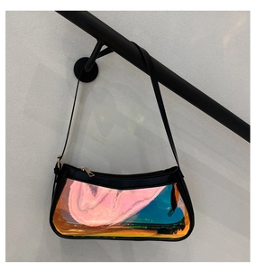 Detail of laser transparent PVC crossbody bag with holographic effect and black strap