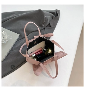 Detailed interior of pink bow tote bag showing magnetic closure and large storage capacity