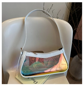 Detailed shot of holographic clear shoulder bag with white strap on a stylish chair