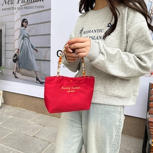 Cute red canvas handbag with colorful beaded handle and gold embroidery for women