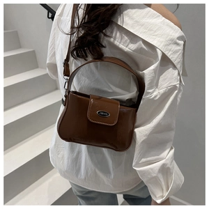 Detailed back view of a brown glossy leather shoulder bag with JWHN metal plate