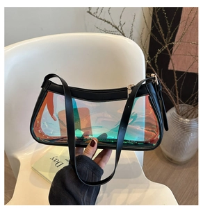Close-up of holographic transparent PVC shoulder bag with black leather trim and zipper