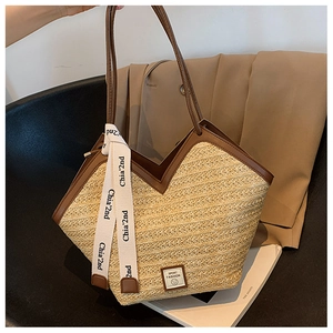 Detail of woven tote bag with brown leather trim and stylish lettered ribbon on a chair