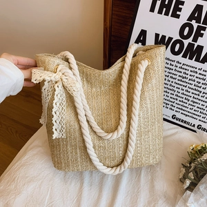 Pastoral beige straw woven tote bag with white rope handles and lace bow decoration