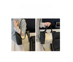Detailed view of color-block tote bag showing both shoulder and handheld carrying styles
