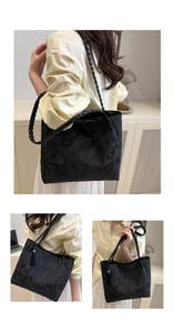 Detail of black lace tote with floral embroidery and braided straps for office use
