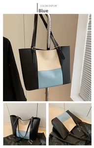 Detail of color-block tote bag in blue and beige with adjustable leather shoulder straps