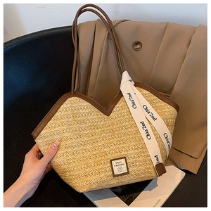 Close-up of woven tote bag showing V-shaped edge with leather trim and Sport Fashion label