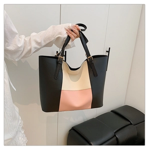 Close-up of tricolor patchwork tote bag showing adjustable handles with gold buckles
