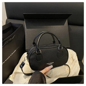 Litchi pattern black bowling bag presented in a luxury gift box with premium tissue