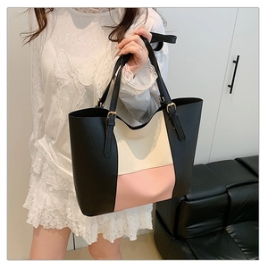 Detail of color-block tote bag in black, beige, and pink leather with metallic buckle