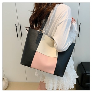 Fashionable large capacity tricolor leather tote bag styled on model in minimalist interior