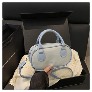 Light blue pebbled leather handbag in a premium black gift box with satin lining