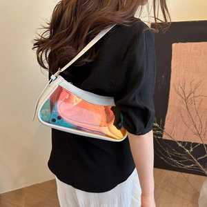 Holographic PVC crossbody bag with white leather frame worn by a model in casual street style