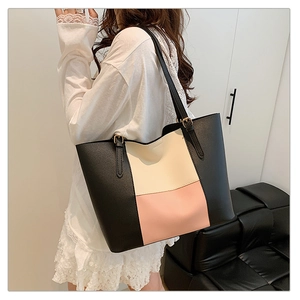 Detail of the three-color patchwork tote bag featuring adjustable gold buckles on straps